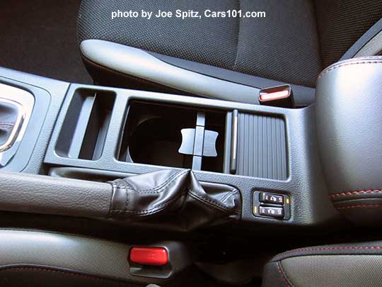loseup of the  center console of the 2016 Crosstrek Premium Special Edition with modular cupholder's retractable cover partly open