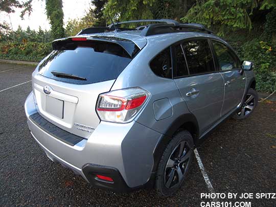rear side view 2016 Subaru Crosstrek Hybrid Touring, ice silver shown,  with optional aero cross bars and rear bumper cover
