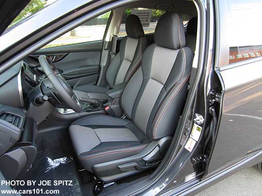 2018 Subaru Crosstrek Premium driver's seat with manual pump-lever height adjustment, black cloth with orange stitching shown.