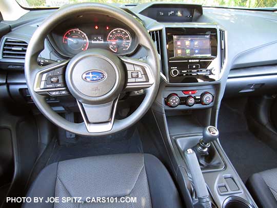 2018 Subaru Crosstrek 2.0i (base model) interior with manual 6speed transmission, gray cloth, black stitching, vinyl covered steering wheel.