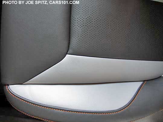 closeup of the 2018 Subaru Crosstrek Limited perforated gray leather seating surfaces with orange stitching and matching leatherette. Its light gray bolsters with dark gray seating area. Driver's seat cushion shownm